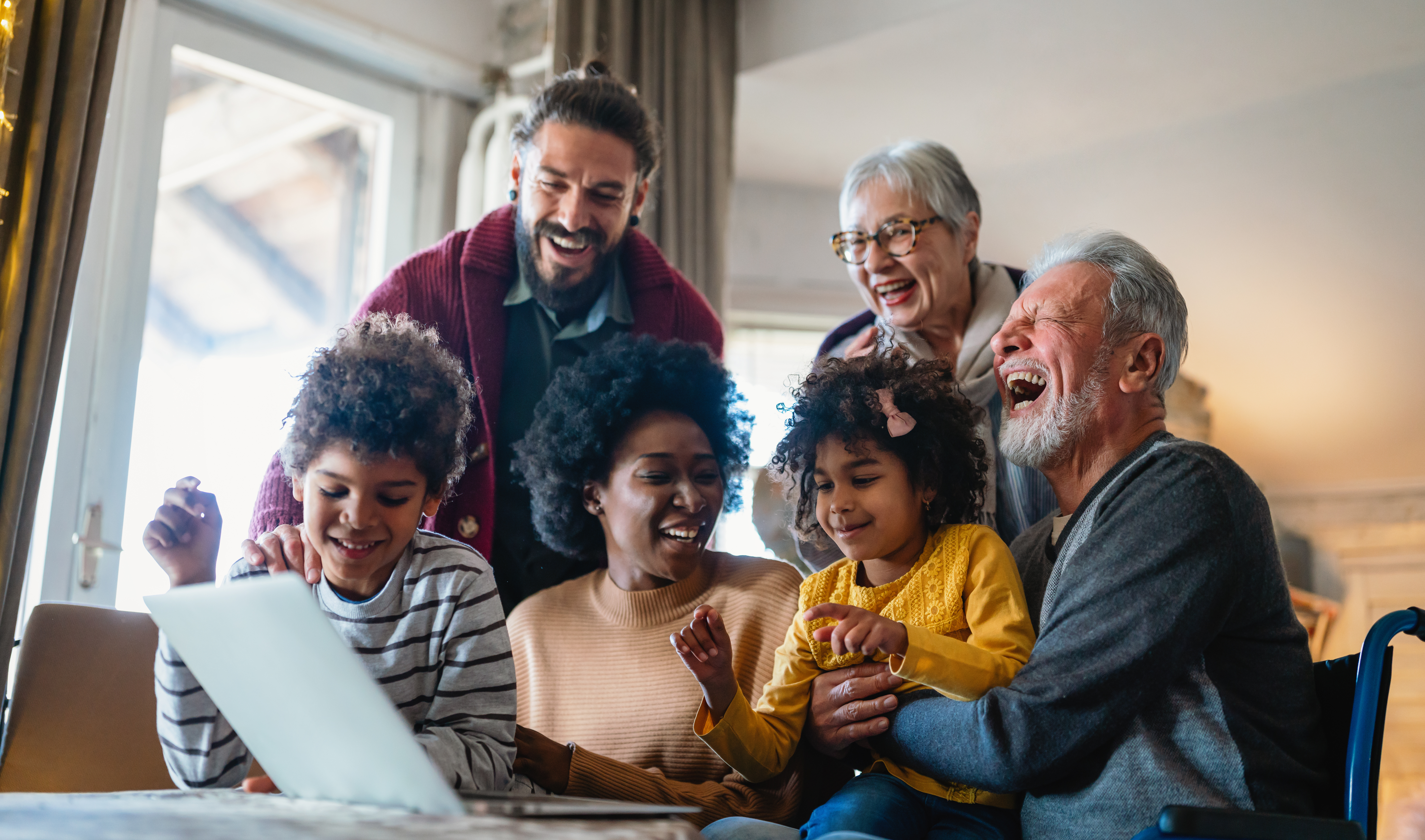 Portrait of a happy multigenerational multiethnic family at home. People group technology love concept