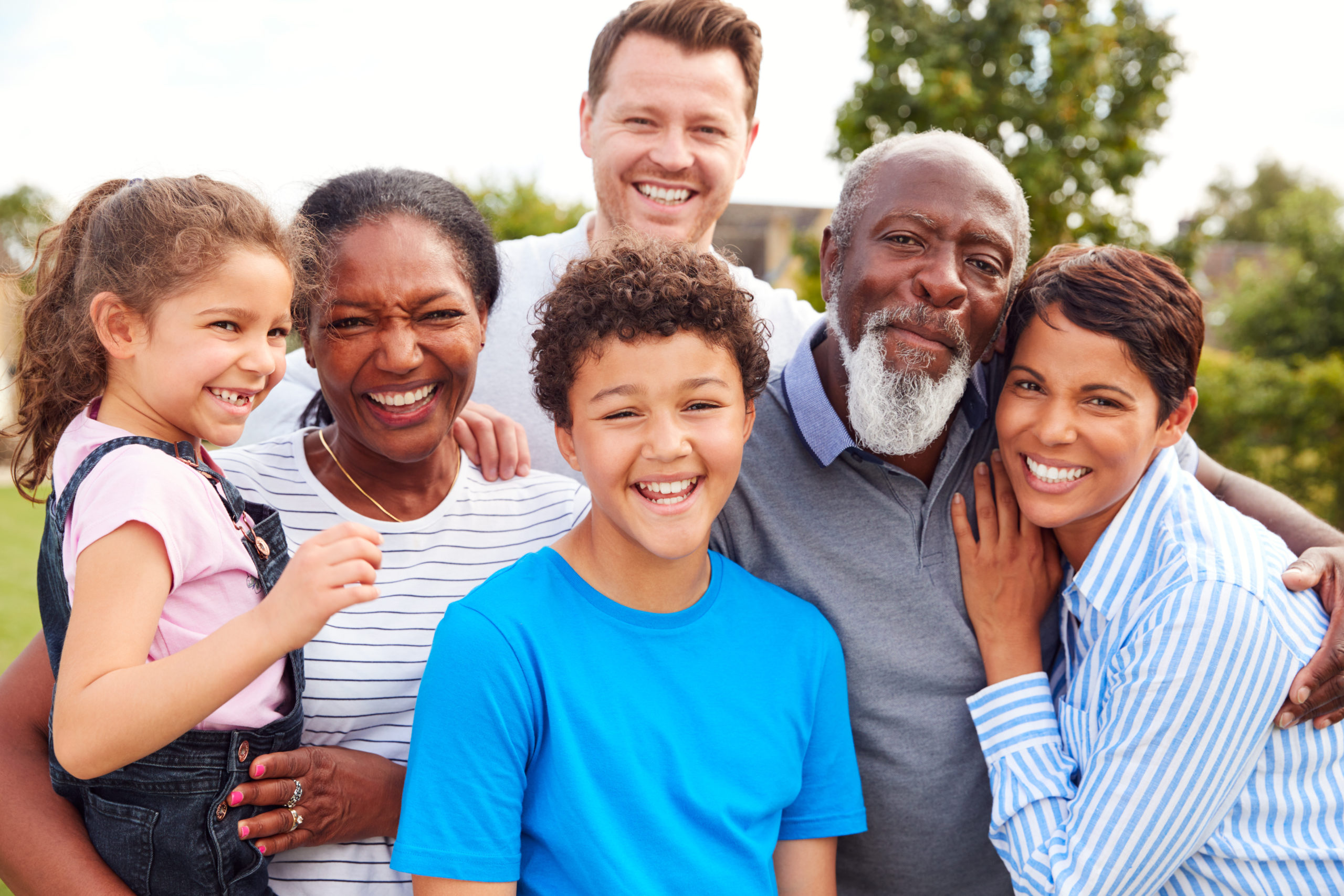 Portrait Of Smiling Multi-Generation Mixed Race Family In Garden At Home