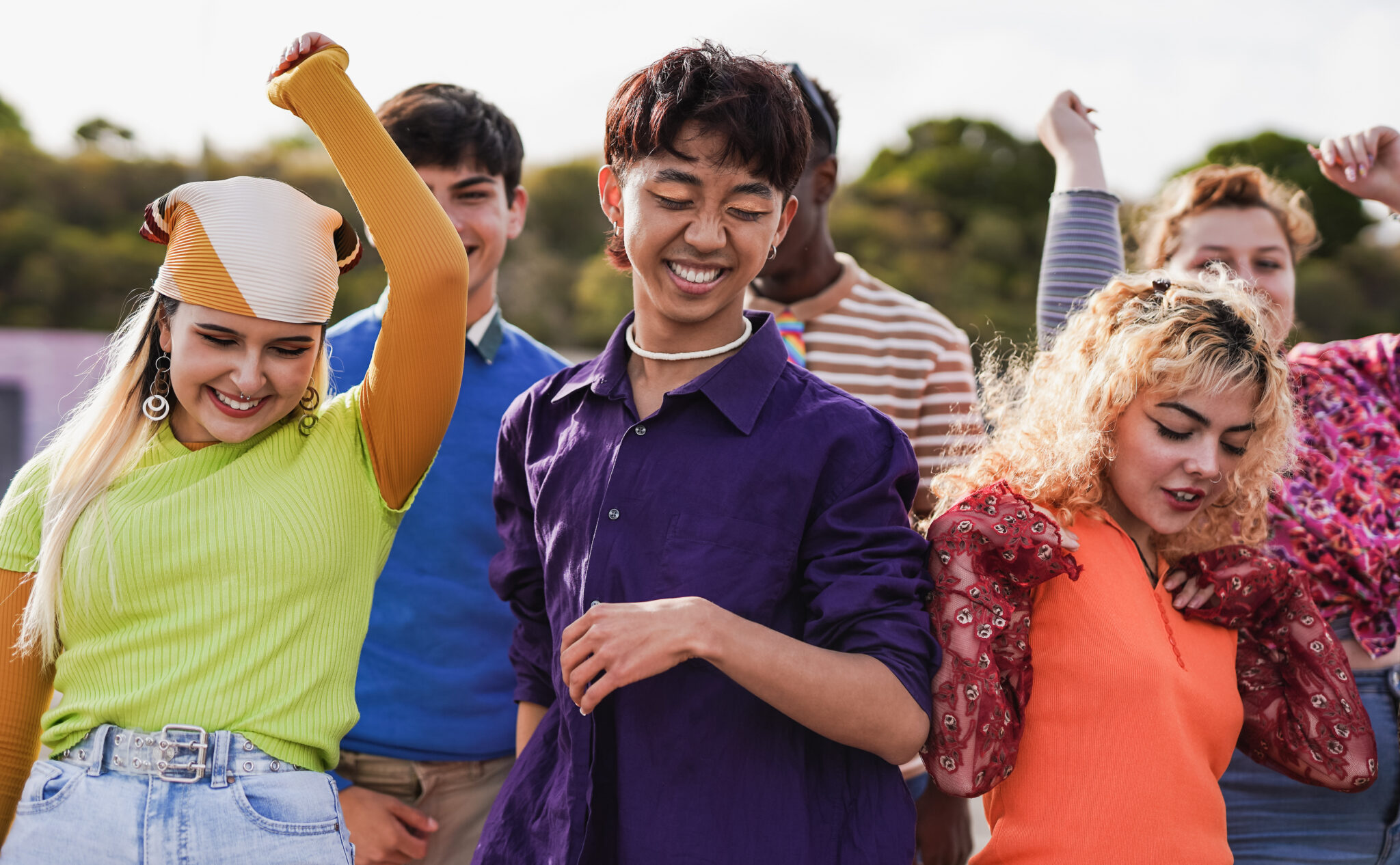 Group of diverse young people dancing outdoor - Summer concert and multiracial friends concept
